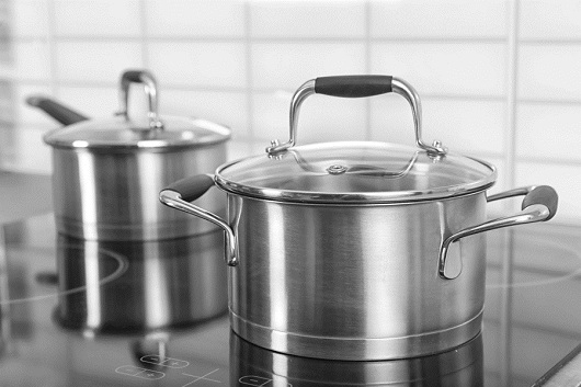 Metal saucepan on electric stove in kitchen Pan